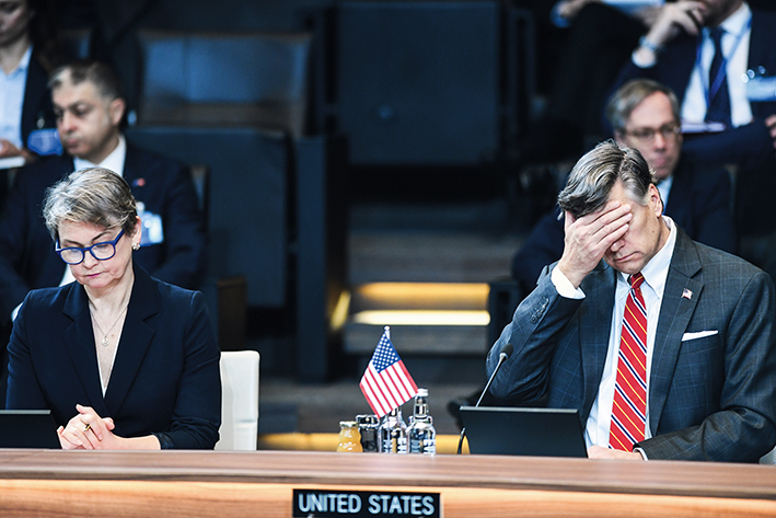 2025年12月3日，在比利时首都布鲁塞尔，英国外交大臣库珀（左）和代替美国国务卿鲁比奥出席的美国常务副国务卿兰多参加北约外长会 彭子洋摄/本刊